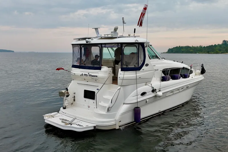 A Mi Manera Yacht Photos Pics 2007 Sea Ray 40 Motor Yacht on calm water, overcast sky, rear view.