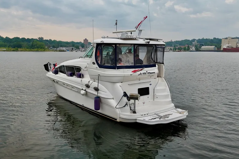 A Mi Manera Yacht Photos Pics 2007 Sea Ray 40 Motor Yacht on calm water, overcast sky in the background.