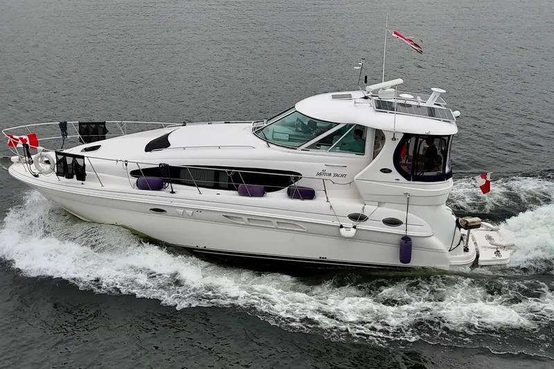 A Mi Manera Yacht Photos Pics 2007 Sea Ray 40 Motor Yacht cruising on open water, displaying Canadian flags.