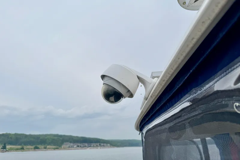 A Mi Manera Yacht Photos Pics Security camera on 2007 Sea Ray 40 Motor Yacht, overlooking serene waters and distant shoreline.