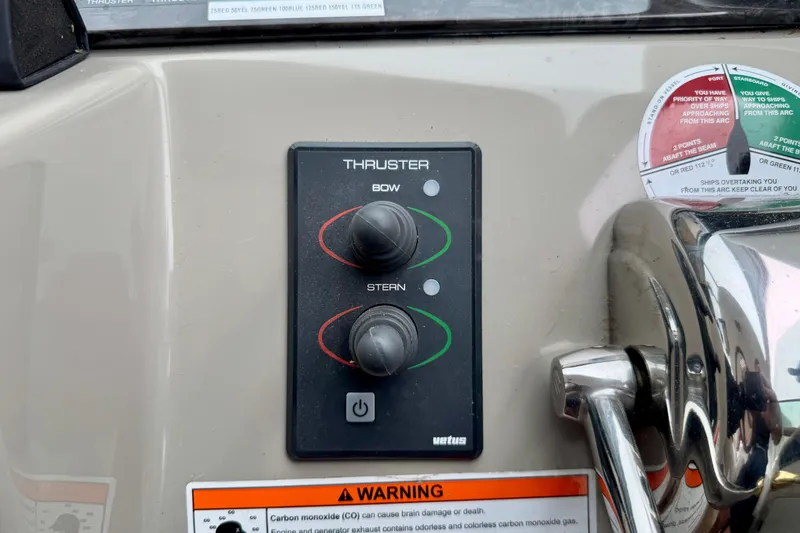 A Mi Manera Yacht Photos Pics Control panel of 2007 Sea Ray 40 Motor Yacht with thruster controls and warning labels.