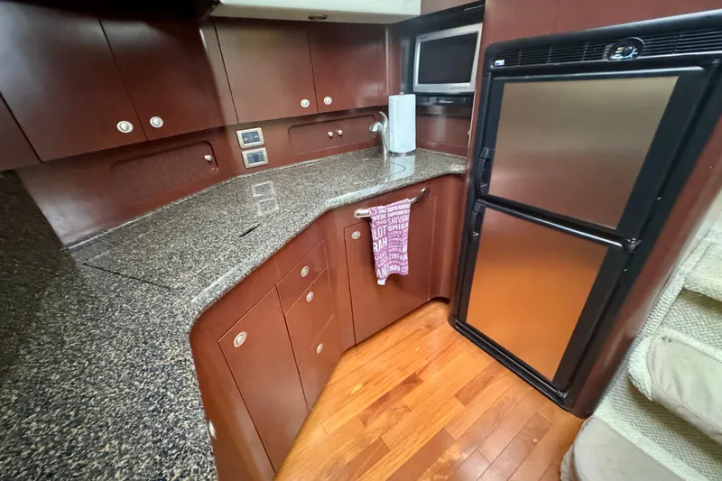 A Mi Manera Yacht Photos Pics 2007 Sea Ray 40 Motor Yacht kitchen with granite countertops and stainless steel appliances.