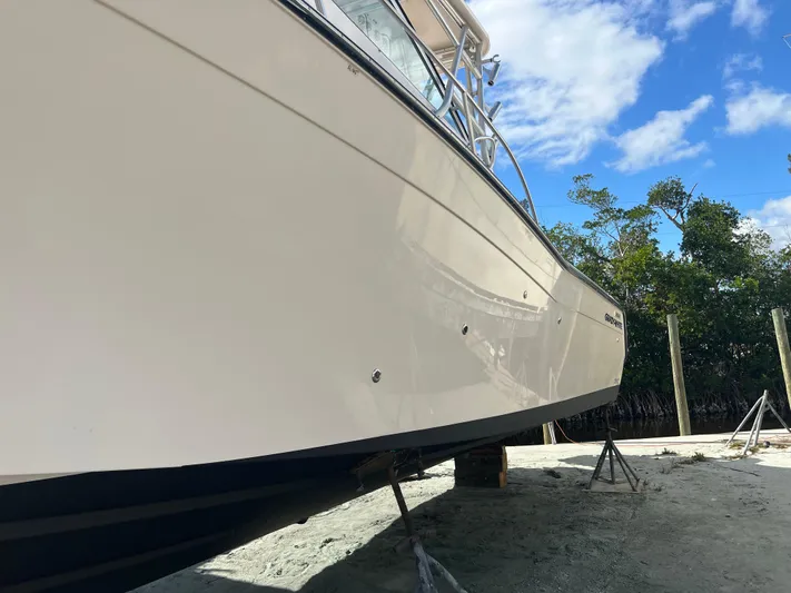  Yacht Photos Pics 2006 Grady-White 360 Express boat on stands, side view, clear sky background.