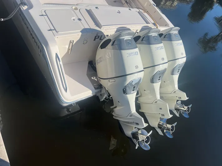  Yacht Photos Pics 2006 Grady-White 360 Express boat with triple outboard engines, docked on calm water.