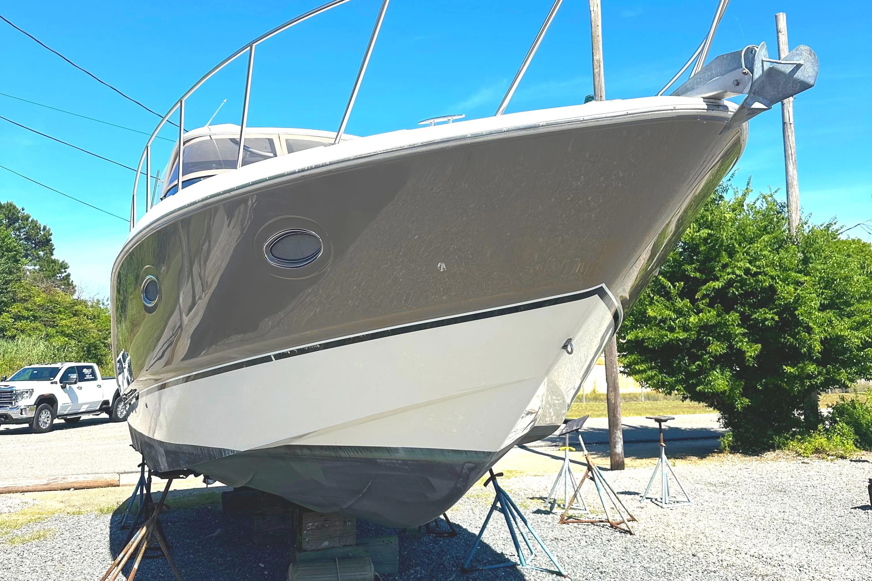 2006 Larson Cabrio 350 boat on stands, sunny day, side view.