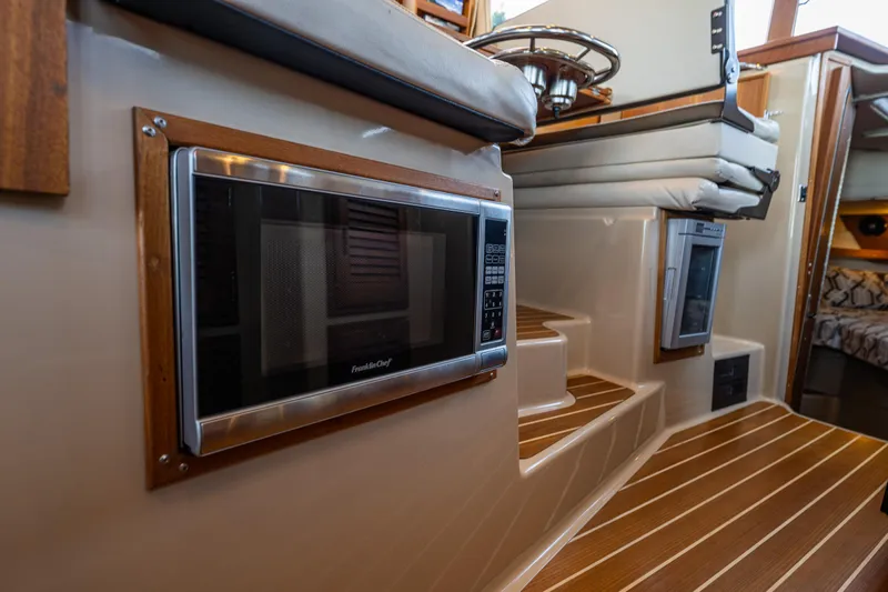 The Western Yacht Photos Pics 2014 Ranger Tugs R-31CB interior with microwave and wooden steps.
