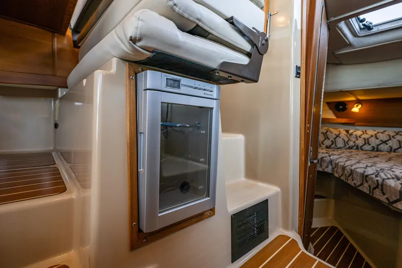 The Western Yacht Photos Pics 2014 Ranger Tugs R-31CB interior with compact fridge and cozy cabin space.