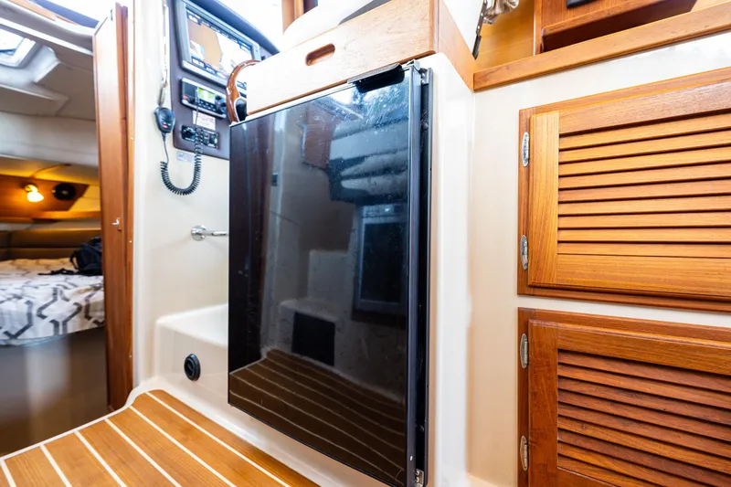 The Western Yacht Photos Pics 2014 Ranger Tugs R-31CB interior with wood cabinetry and modern appliances.