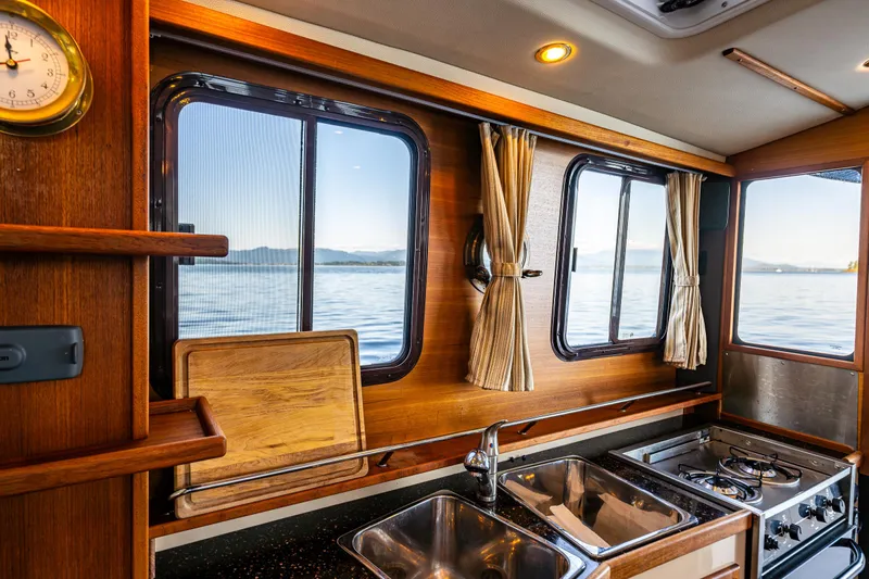 The Western Yacht Photos Pics Cozy 2014 Ranger Tugs R-31CB kitchen with wood accents and ocean view.