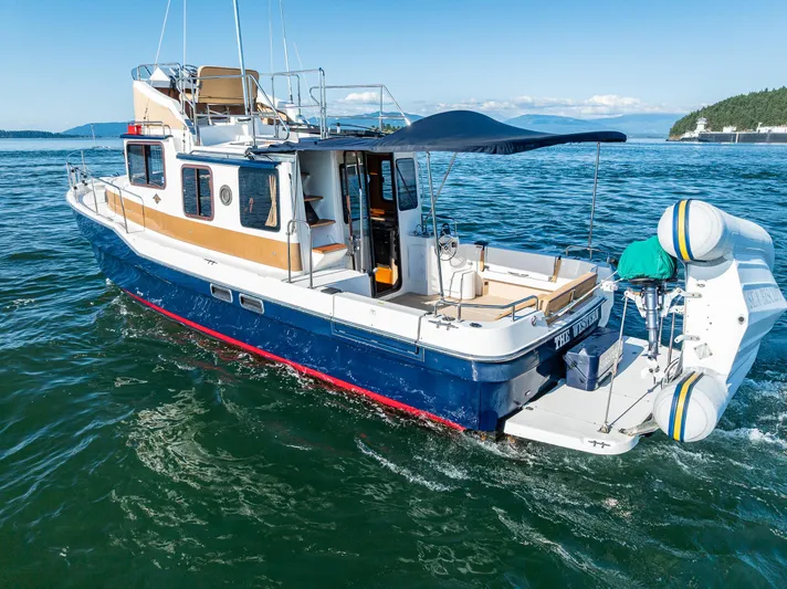 The Western Yacht Photos Pics 2014 Ranger Tugs R-31CB cruising on open water, featuring a spacious deck and modern design.