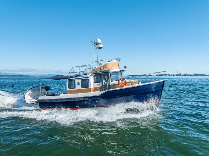 The Western Yacht Photos Pics 2014 Ranger Tugs R-31CB cruising on open water under clear blue skies.
