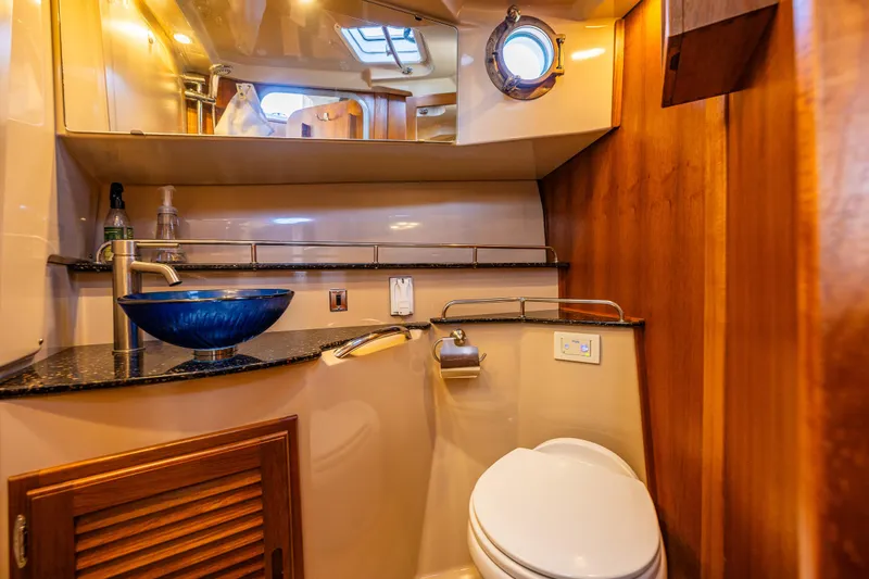 The Western Yacht Photos Pics Luxurious 2014 Ranger Tugs R-31CB bathroom with modern sink and wooden accents.