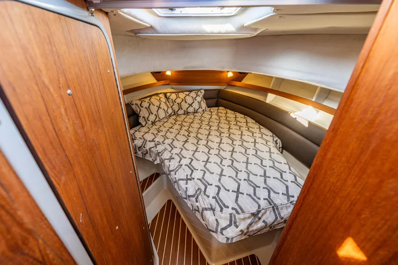 The Western Yacht Photos Pics Cozy cabin interior of 2014 Ranger Tugs R-31CB with patterned bedding and wood accents.