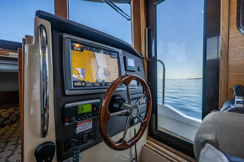 The Western Yacht Photos Pics 2014 Ranger Tugs R-31CB helm with navigation display and wooden steering wheel.