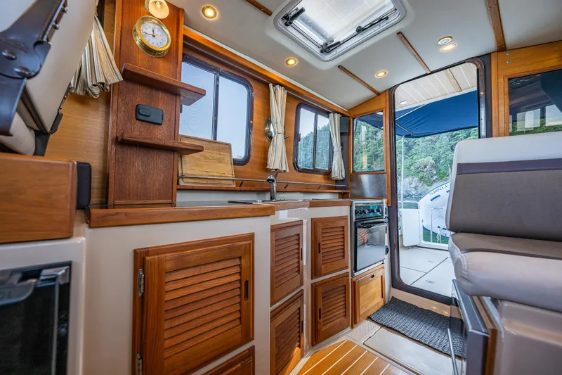 The Western Yacht Photos Pics Interior of 2014 Ranger Tugs R-31CB boat with wood cabinetry and seating.