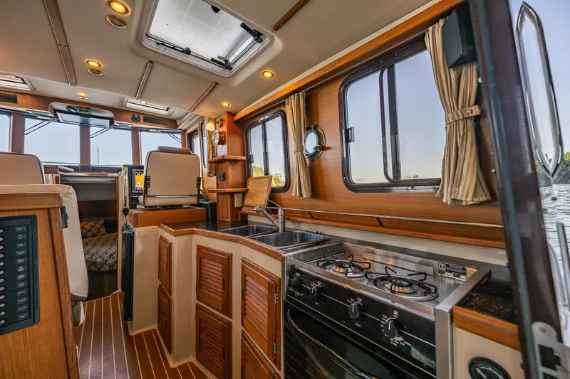 The Western Yacht Photos Pics Interior of 2014 Ranger Tugs R-31CB boat with kitchen and seating area.