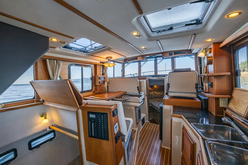 The Western Yacht Photos Pics Interior of 2014 Ranger Tugs R-31CB boat with wood accents and modern amenities.