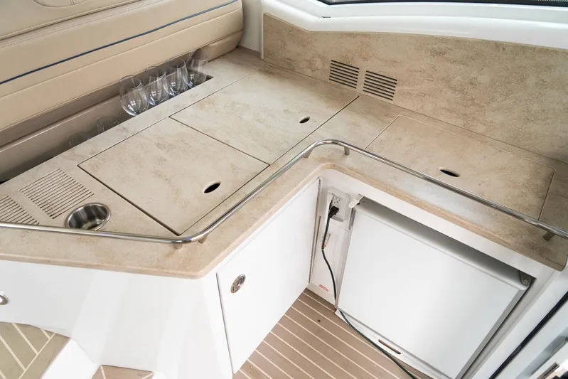  Yacht Photos Pics 2016 Formula 45 Yacht interior with beige countertop and built-in mini fridge.