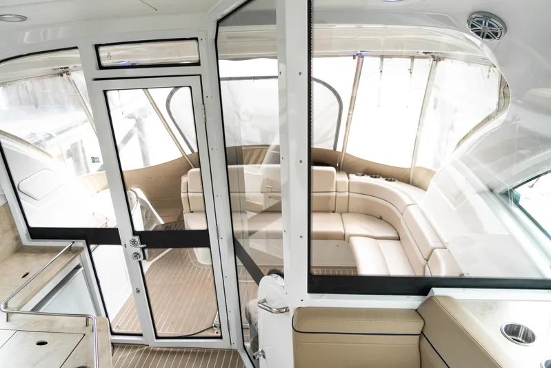  Yacht Photos Pics Interior view of a 2016 Formula 45 Yacht with beige seating and glass doors.