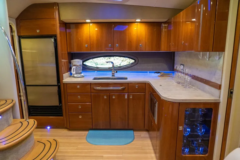  Yacht Photos Pics Luxurious kitchen interior of 2016 Formula 45 Yacht with wood cabinetry and modern appliances.