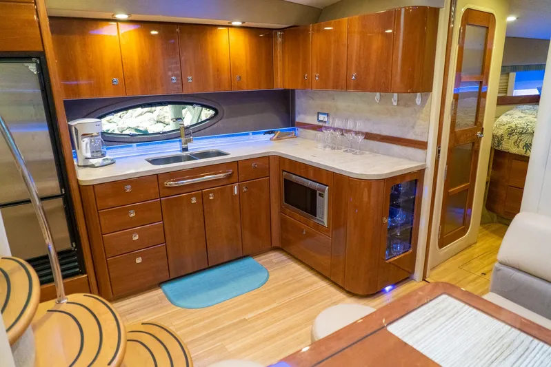  Yacht Photos Pics Luxurious kitchen interior of 2016 Formula 45 Yacht with wood cabinetry and modern appliances.
