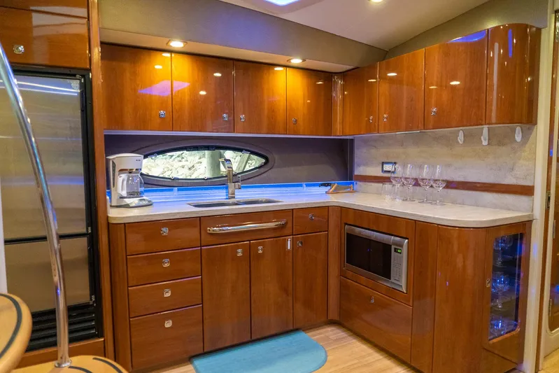  Yacht Photos Pics Luxurious kitchen interior of 2016 Formula 45 Yacht with wood cabinets and modern appliances.