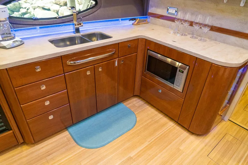  Yacht Photos Pics Luxurious 2016 Formula 45 Yacht kitchen with wood cabinetry, sink, and microwave.