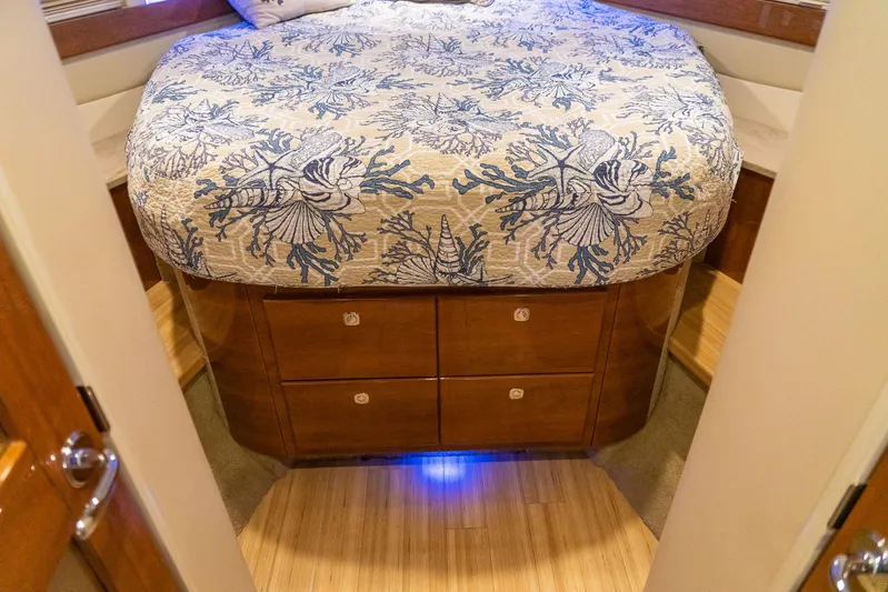  Yacht Photos Pics Luxurious bedroom interior of 2016 Formula 45 Yacht with floral bedding and wooden drawers.