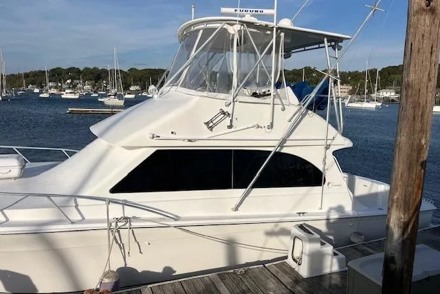 2001 Egg Harbor 42 SportYacht docked at marina, surrounded by calm waters and other boats.