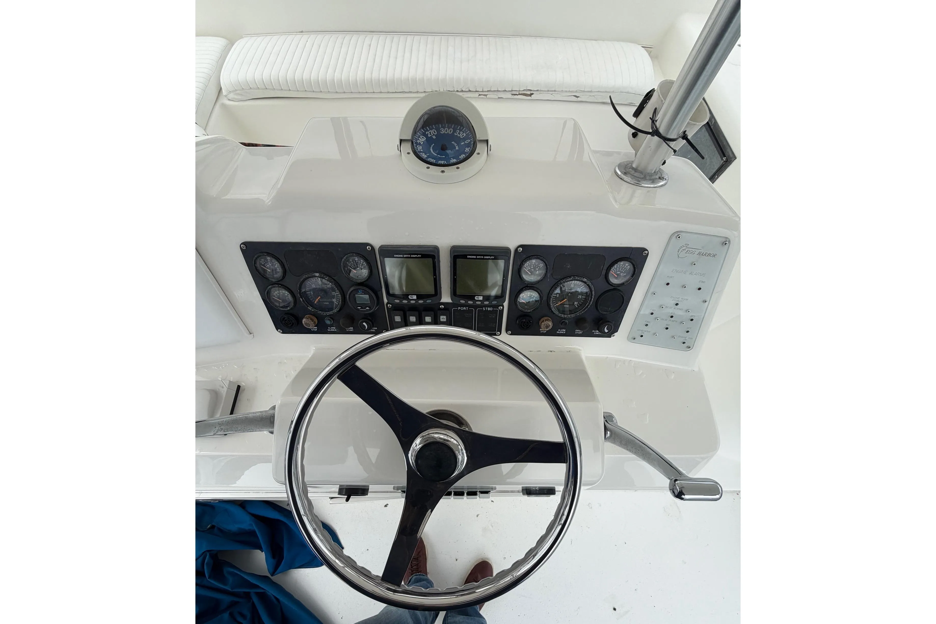 Steering console of a 2001 Egg Harbor 42 SportYacht with gauges and controls.