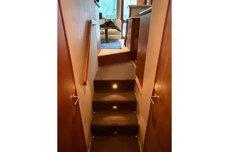 Ronnie H Yacht Photos Pics Stairway inside 2001 Egg Harbor 42 SportYacht with wooden handrails and carpeted steps.
