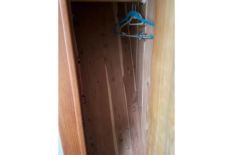 Ronnie H Yacht Photos Pics Wooden closet interior with hangers, inside a 2001 Egg Harbor 42 SportYacht.