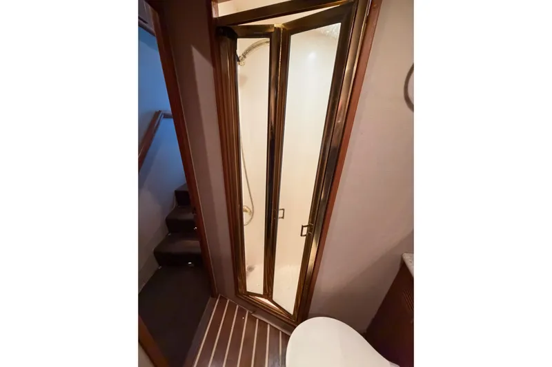 Ronnie H Yacht Photos Pics Bathroom interior of 2001 Egg Harbor 42 SportYacht with shower and wooden accents.