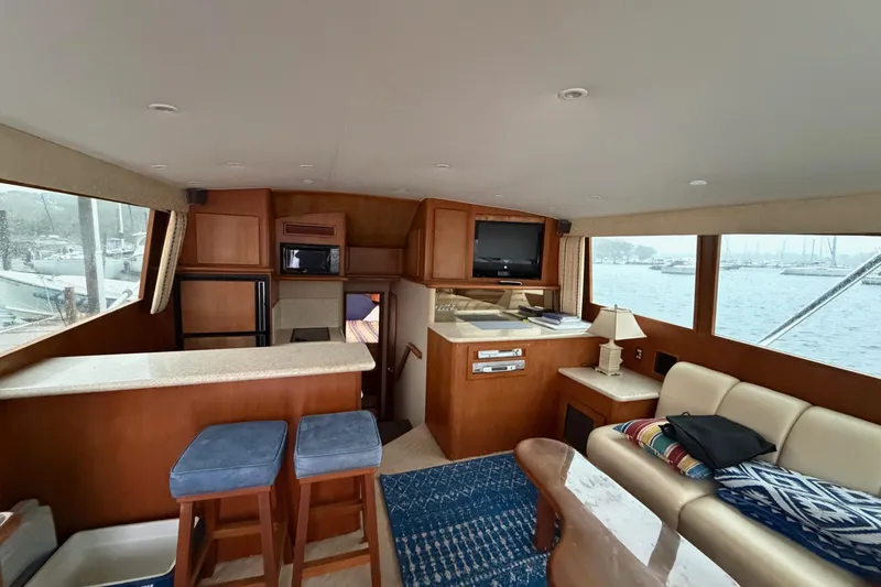 Ronnie H Yacht Photos Pics Interior of 2001 Egg Harbor 42 SportYacht with seating, bar stools, and waterfront view.