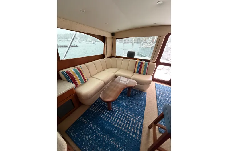 Ronnie H Yacht Photos Pics Luxurious interior of 2001 Egg Harbor 42 SportYacht with beige seating and colorful cushions.