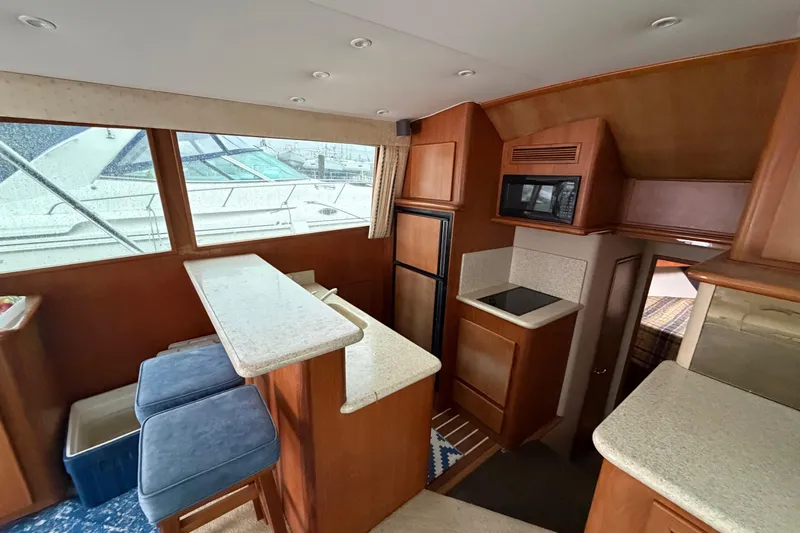 Ronnie H Yacht Photos Pics Interior of 2001 Egg Harbor 42 SportYacht with kitchen and seating area.
