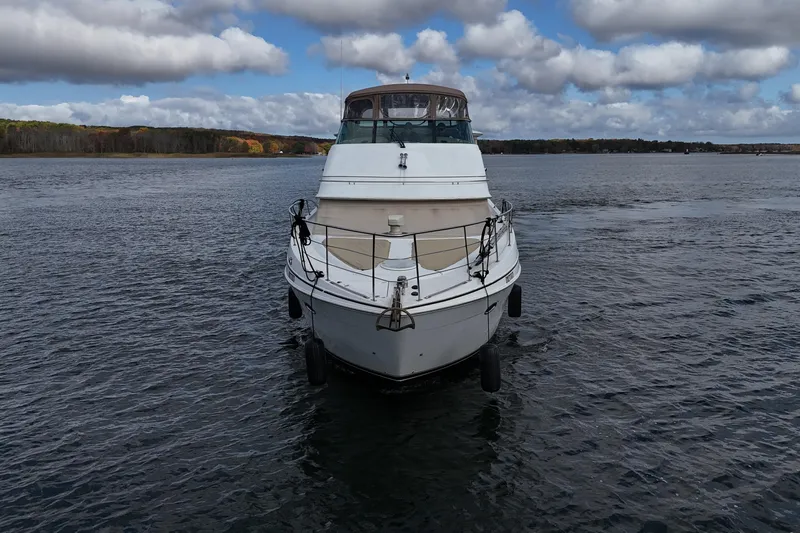  Yacht Photos Pics 2002 Carver 466 Motor Yacht on calm water under cloudy sky.