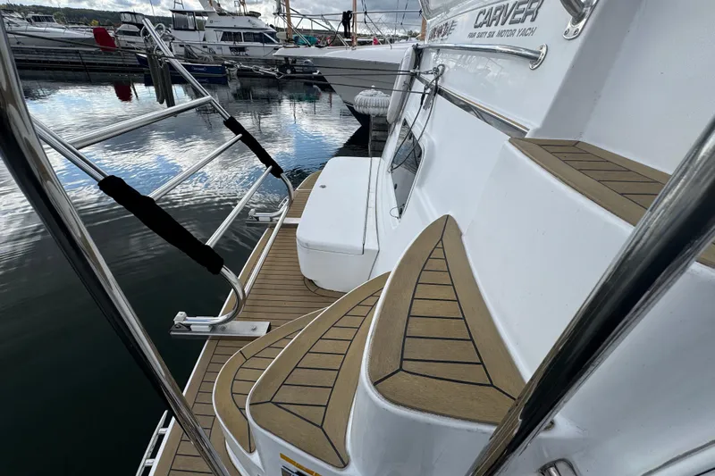 Yacht Photos Pics 2002 Carver 466 Motor Yacht docked, featuring elegant teak steps and stainless steel railings.