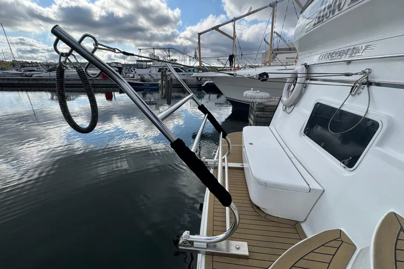  Yacht Photos Pics 2002 Carver 466 Motor Yacht docked, featuring a sleek deck and stainless steel railings.