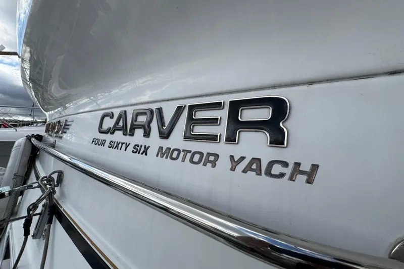  Yacht Photos Pics 2002 Carver 466 Motor Yacht nameplate on white hull, showcasing luxury design.