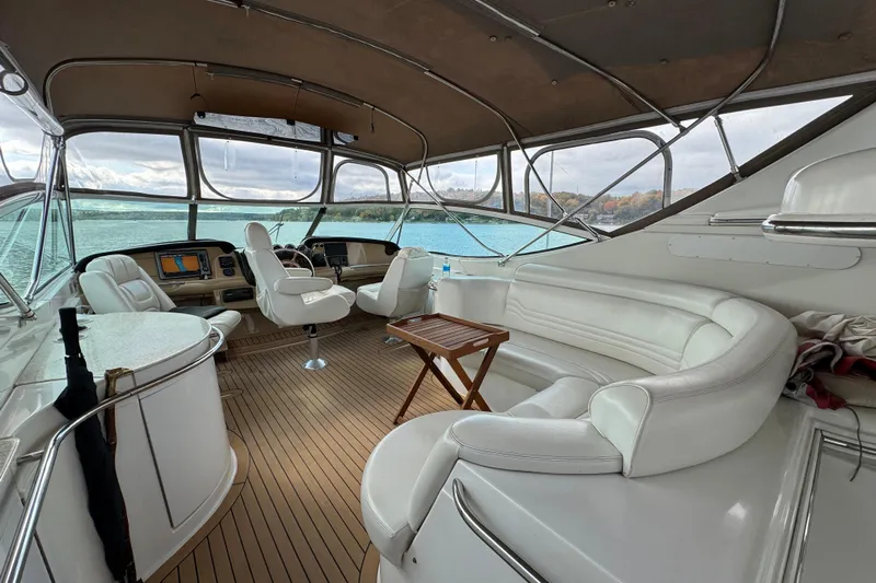  Yacht Photos Pics Luxurious 2002 Carver 466 Motor Yacht interior with white seating and panoramic windows.