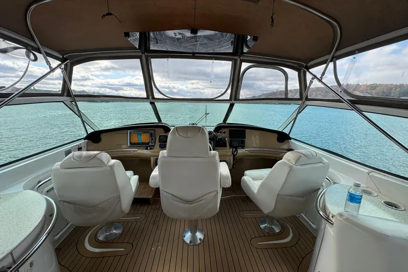  Yacht Photos Pics Interior view of 2002 Carver 466 Motor Yacht cockpit with three white chairs.