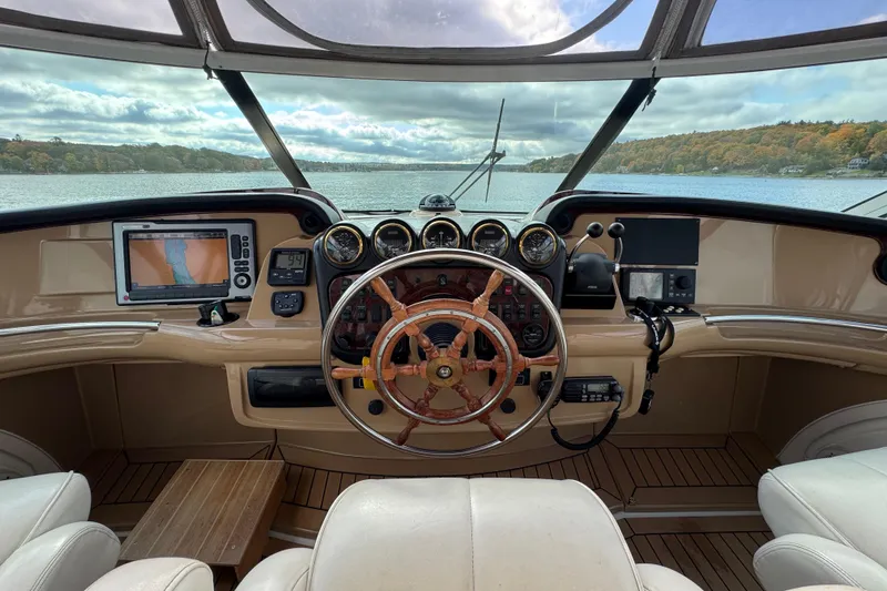  Yacht Photos Pics Helm of 2002 Carver 466 Motor Yacht with navigation equipment and scenic water view.