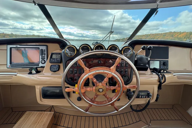  Yacht Photos Pics Helm of 2002 Carver 466 Motor Yacht with navigation equipment and wooden steering wheel.