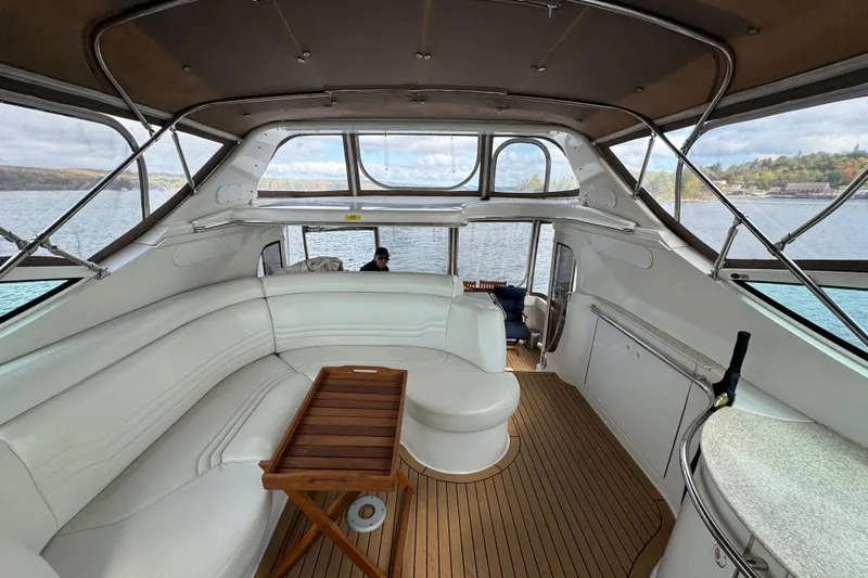  Yacht Photos Pics Interior of 2002 Carver 466 Motor Yacht with white seating and wooden flooring.