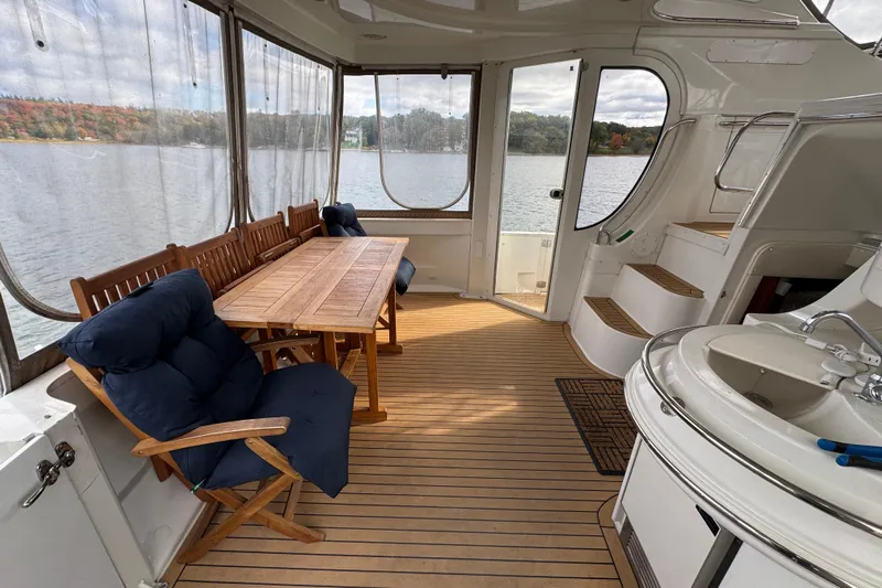  Yacht Photos Pics Luxurious 2002 Carver 466 Motor Yacht interior with dining area and scenic water view.