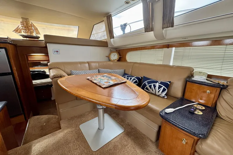  Yacht Photos Pics Interior of 2002 Carver 466 Motor Yacht with elegant seating and wooden table.