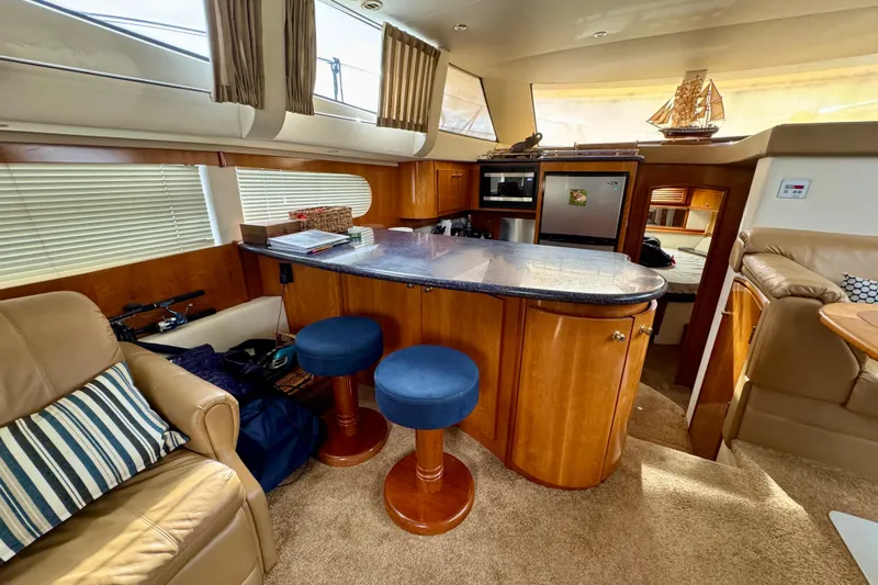  Yacht Photos Pics Luxurious interior of 2002 Carver 466 Motor Yacht with modern kitchen and seating area.