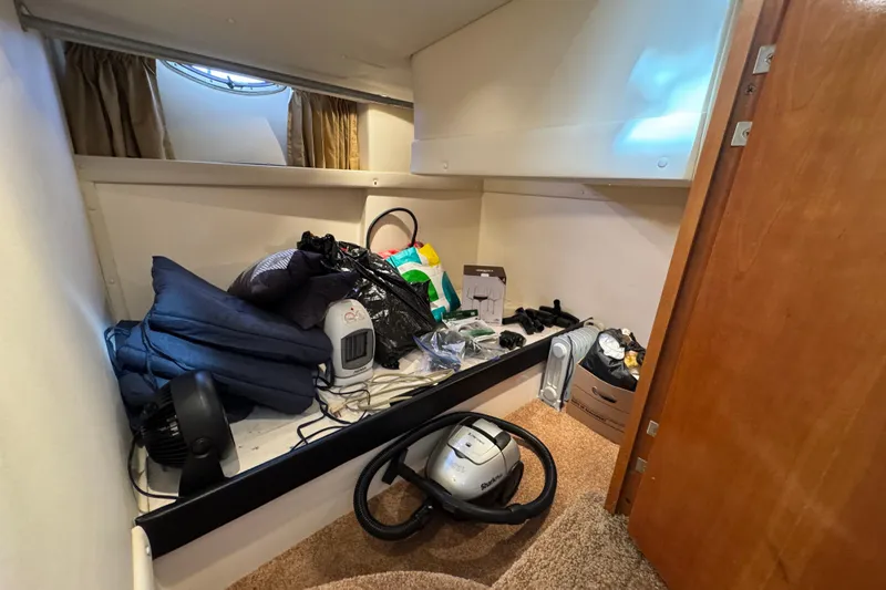  Yacht Photos Pics Storage area inside 2002 Carver 466 Motor Yacht with various items and equipment.