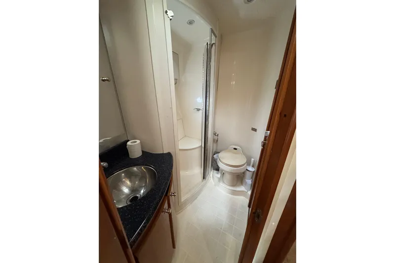  Yacht Photos Pics 2002 Carver 466 Motor Yacht bathroom with shower, sink, and toilet.